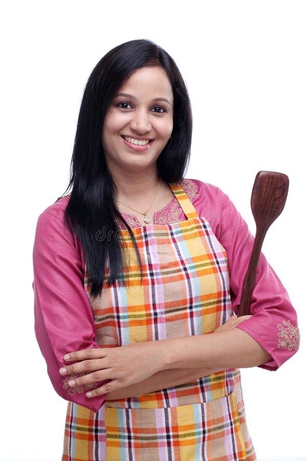 Young Indian woman holding wooden spoon stock photo Young Indian woman holding wooden spoon stock photo