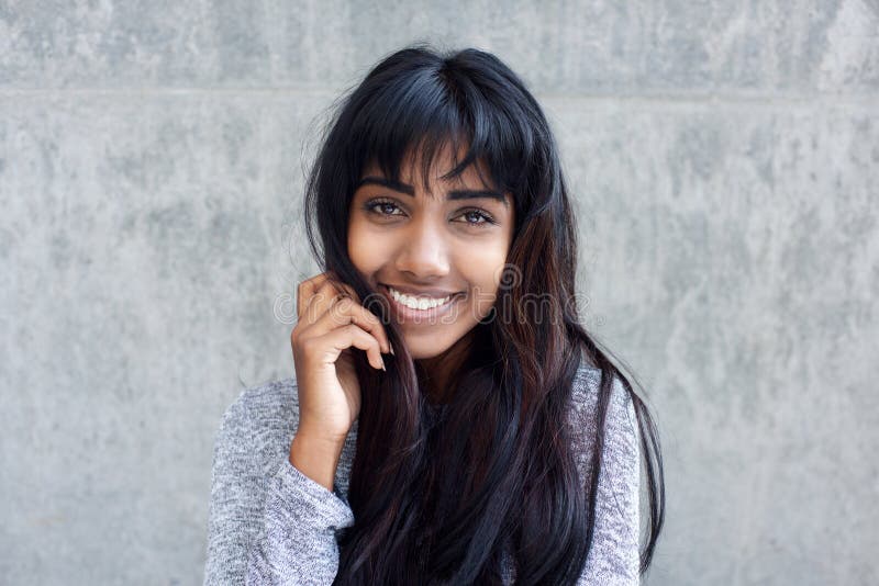 Profile of Indian woman smiling and touching her hair Stock Photo - Alamy