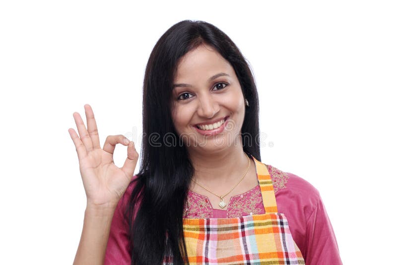 Young Indian woman wearing kitchen apron royalty free stock photo Young Indian woman wearing kitchen apron royalty free stock photo