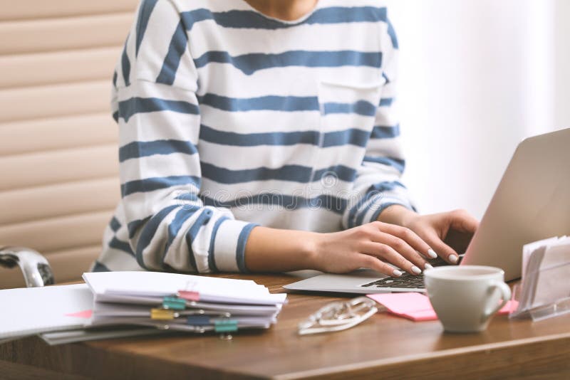 Young journalist working with laptop in office stock photography