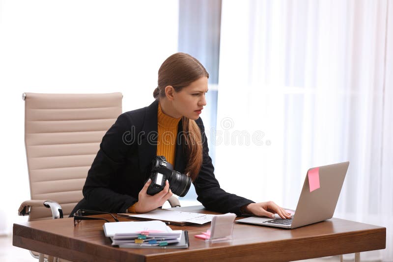 Young journalist working at table stock photos