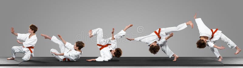 Young judo caucasian male fighter in white kimono with red belt in motion and action during training. Practicing martial