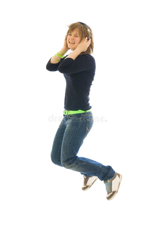 The young jumping girl with a headphones