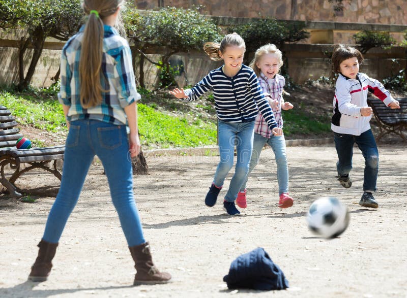 Young kids playing street football outdoors stock images Young kids playing street football outdoors stock images
