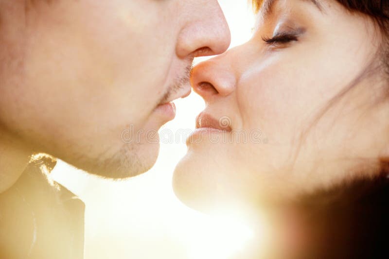 Young kissing couple at sunshine