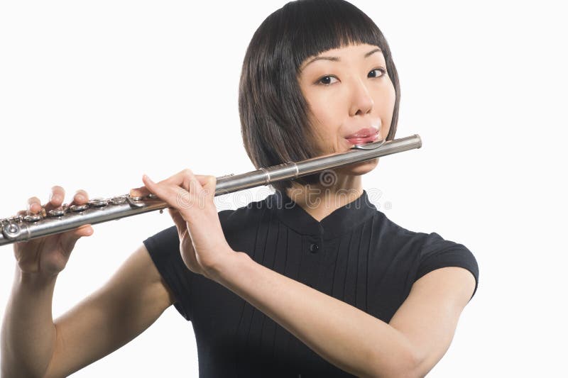 Young Korean Woman Playing Flute royalty free stock photos
