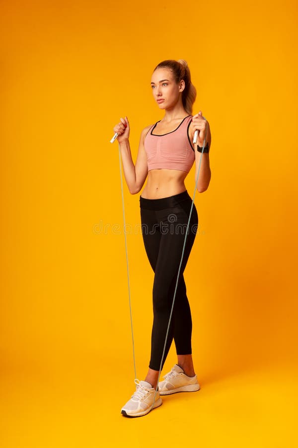 Young Lady Doing Jump Rope Exercise During Workout In Studio stock image Young Lady Doing Jump Rope Exercise During Workout In Studio stock image