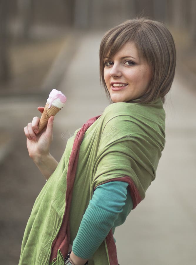 A young lady enjoying an ice cream cone