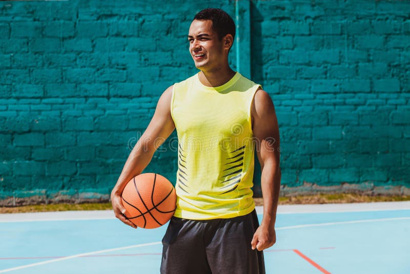 Young latin man playing basketball portrait in Mexico stock photo