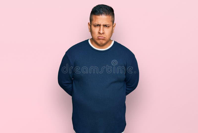 Young latin man wearing casual clothes skeptic and nervous, frowning upset because of problem