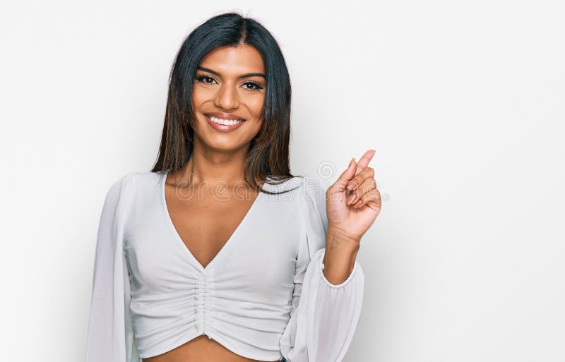 Young latin transsexual transgender woman wearing casual clothes with a big smile on face, pointing with hand finger to the side