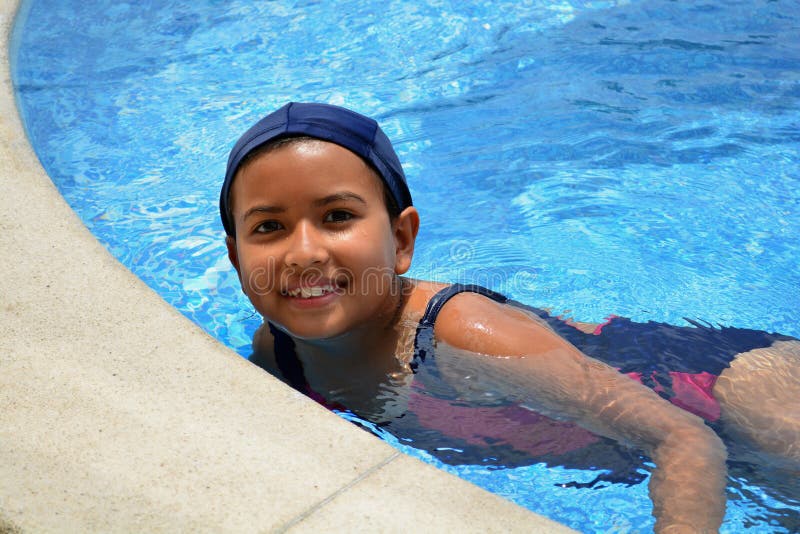 A young latinamerican girl in the swimming pool.