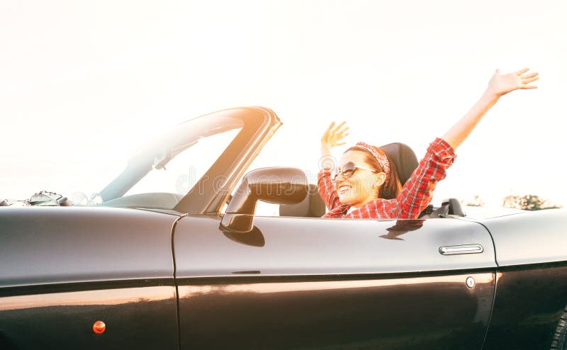 Young laughing female cheerful rising hands up in by cabriolet car in sunny day time royalty free stock photo Young laughing female cheerful rising hands up in by cabriolet car in sunny day time royalty free stock photo