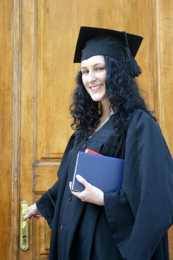 Young laughing student in gown