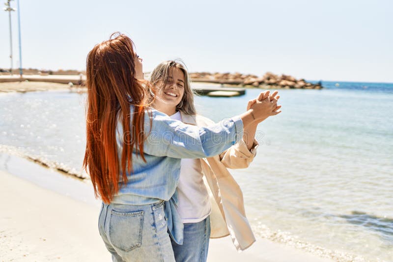 Young Lesbian Couple Of Two Women In Love At The Beach Stock Image