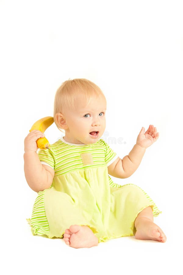 Young little baby eat yellow banana