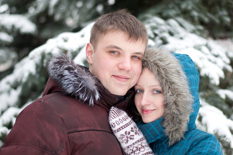 Young lovers woman and man in winter forest