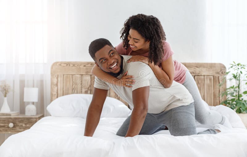 Young Loving African Couple Having Romantic Times In Bedroom Stock