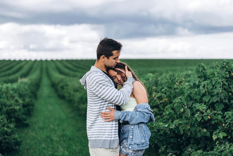 Young Loving Couple Gently Hugging on the Background of Green Currant  Plantations. Love Story Stock Photo - Image of girl, currant: 181948648