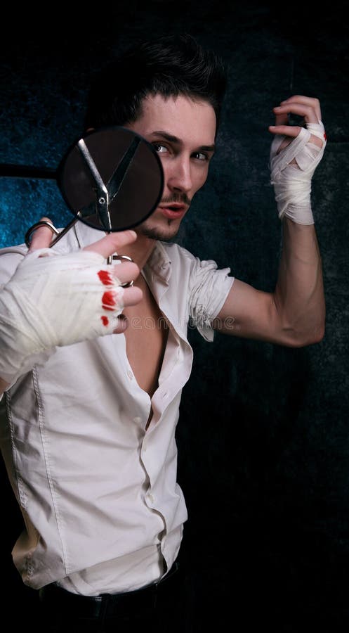 Young macho play with magnifier stock photo