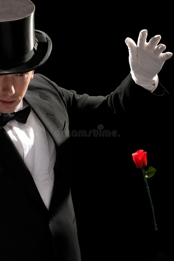 Young magician performing red rose