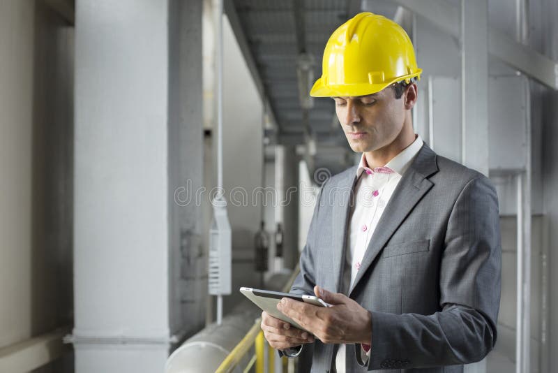 Young male architect using tablet computer in industry stock images