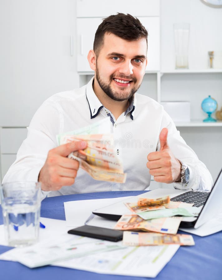 Young male businessman earning money easily online in Internet royalty free stock photo Young male businessman earning money easily online in Internet royalty free stock photo