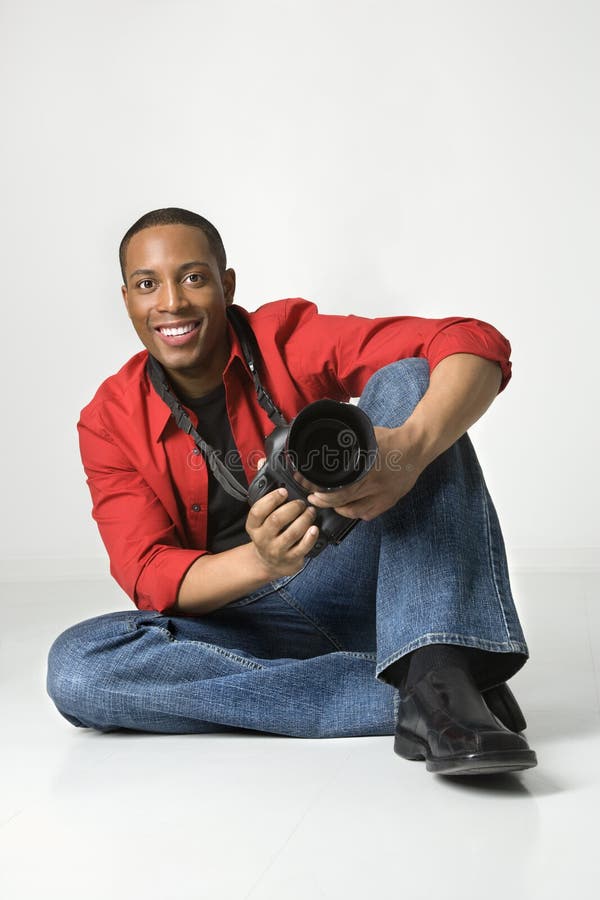 Young male with a camera. stock photos Young male with a camera. stock photos