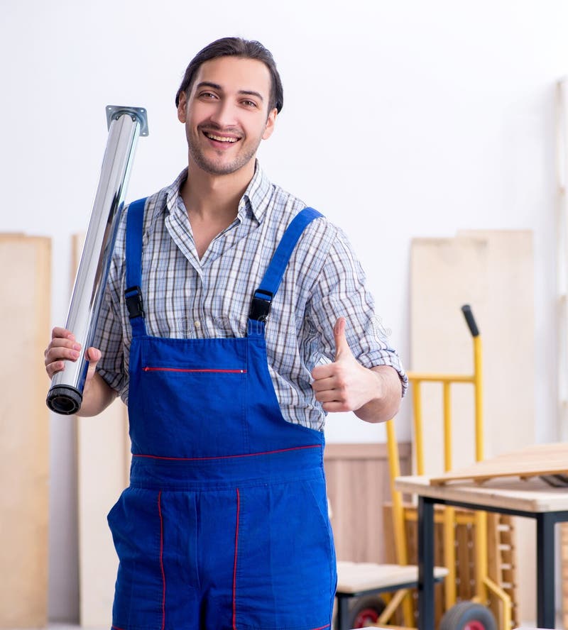 Young male carpenter working indoors royalty free stock image