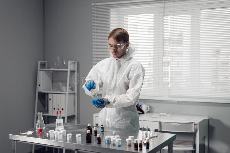 Young male chemist experimenting in a lab royalty free stock photo