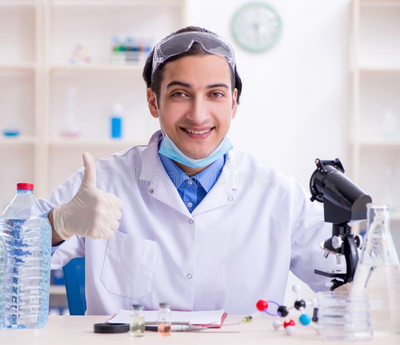 Young male chemist experimenting in lab royalty free stock image