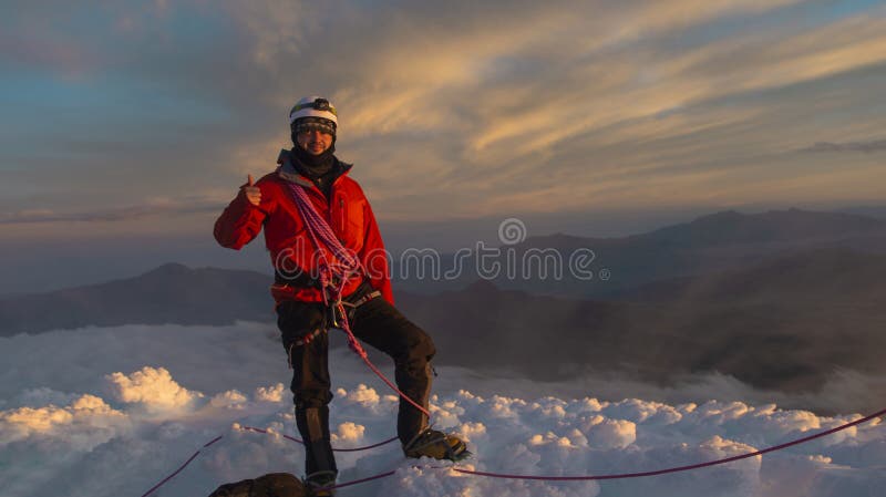 Young Male Climber Standing on the Summit of Cotopaxi Volcano during a ...