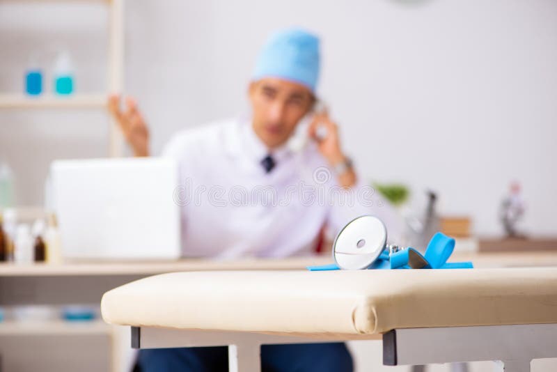 The young male doctor otolaryngologist working at the hospital stock photo The young male doctor otolaryngologist working at the hospital stock photo