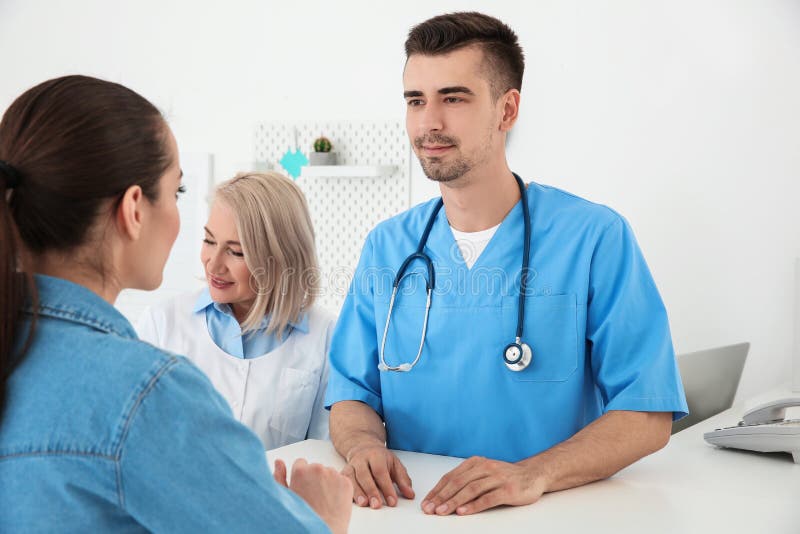 Young male doctor and senior female receptionist royalty free stock photo Young male doctor and senior female receptionist royalty free stock photo