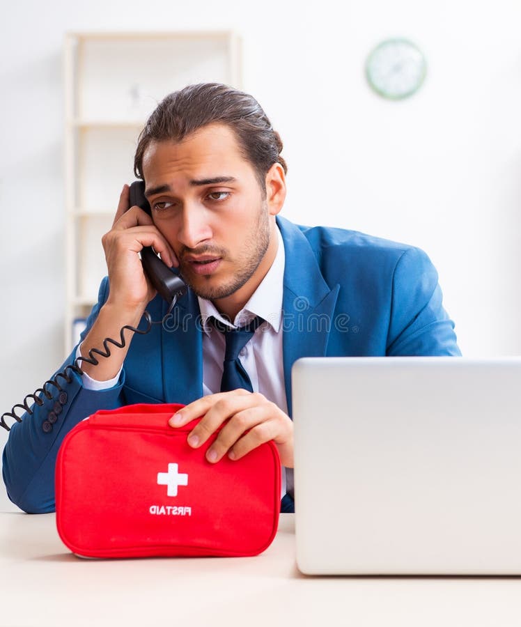 Young male employee in first aid concept stock photography
