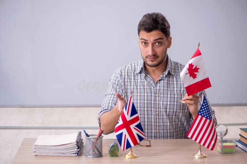 Young Male English Language Teacher in the Classroom Stock Photo
