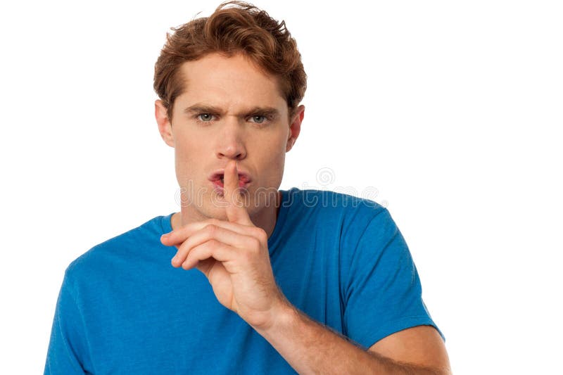 Young male with finger on his lips royalty free stock photo