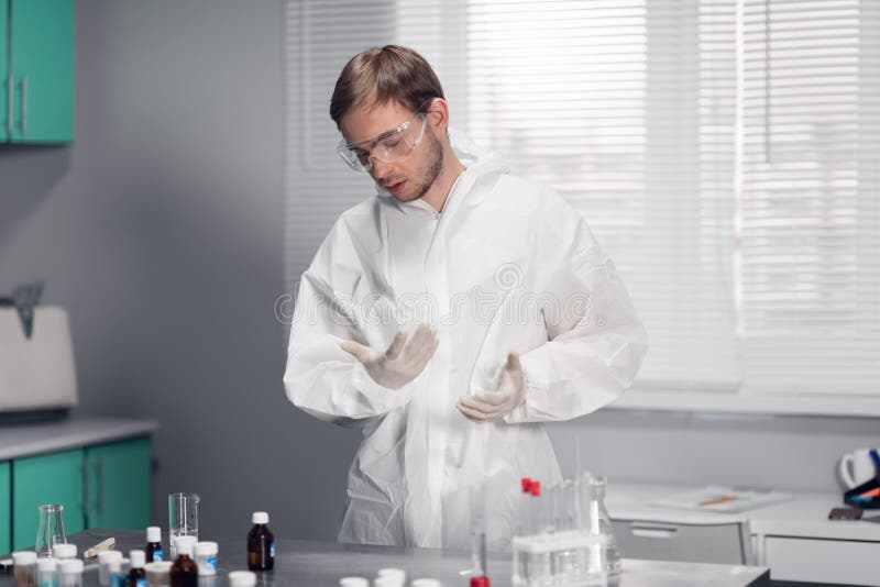 A young male pharmacist at work in a bright, spacious laboratory room royalty free stock photography