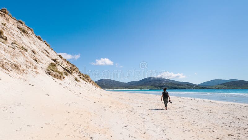 Young male photographer with dreadlocks at a sunny white sand beach with high sand dunes, Luskentyre, Isle of Harris, Hebrides, Sc stock photos Young male photographer with dreadlocks at a sunny white sand beach with high sand dunes, Luskentyre, Isle of Harris, Hebrides, Sc stock photos