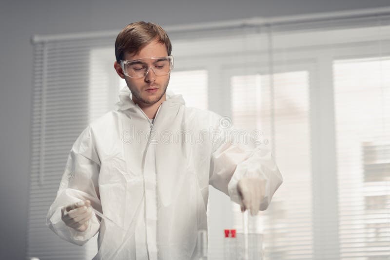 Young male scientist preparing to load the analyzer with samples in laboratory stock photos