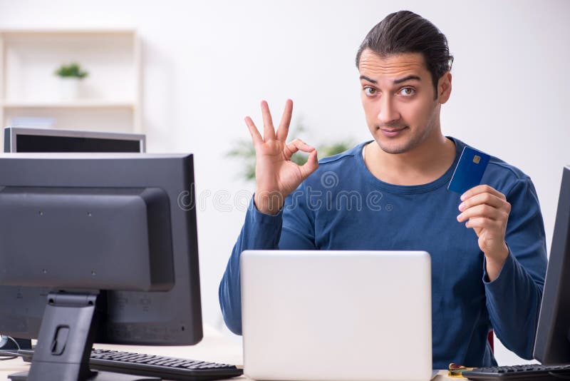 Young male it specialist working in the office royalty free stock photos
