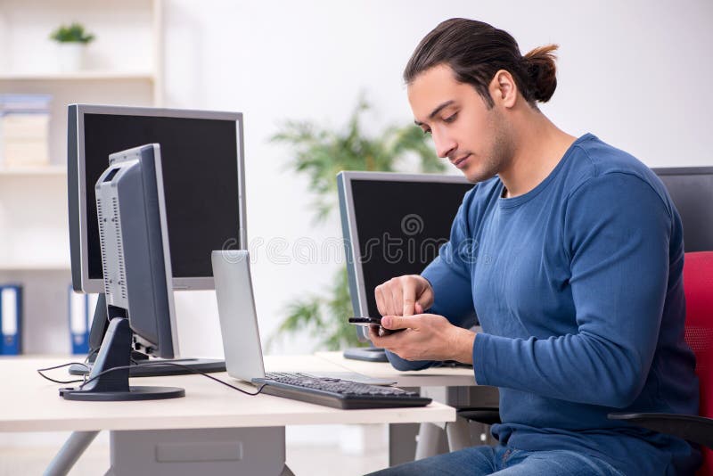 Young male it specialist working in the office royalty free stock image