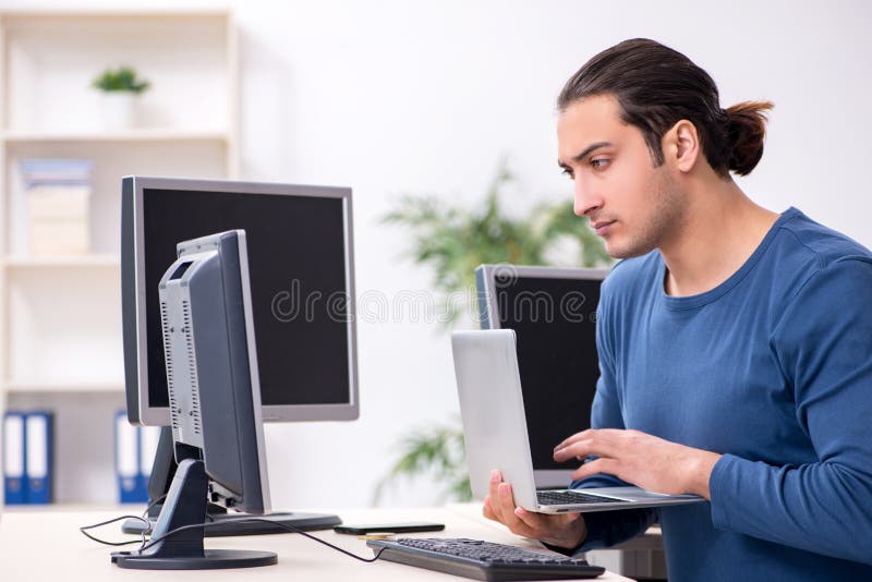 Young male it specialist working in the office royalty free stock images