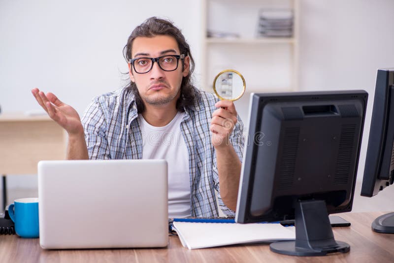 Young male it specialist working in the office royalty free stock photography