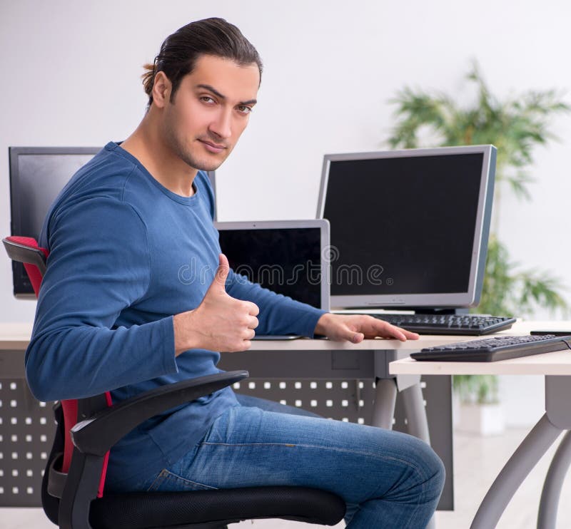 Young male it specialist working in the office royalty free stock photography