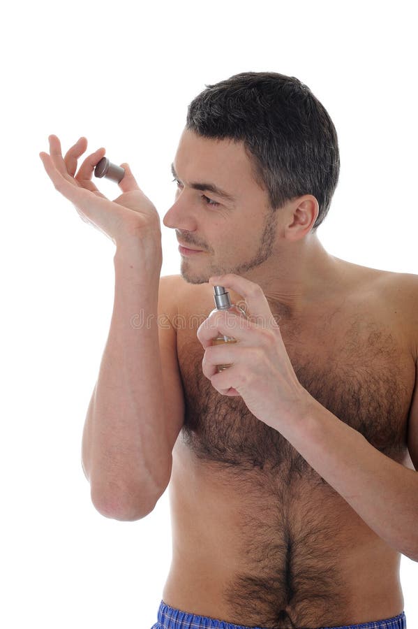 Young male spray perfume on his skin royalty free stock photo