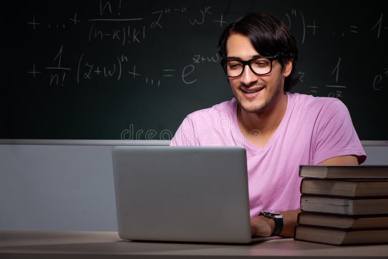 The young male student sitting in classroom