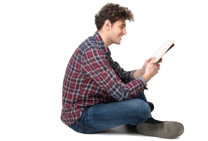 Young male student sitting on the floor stock images