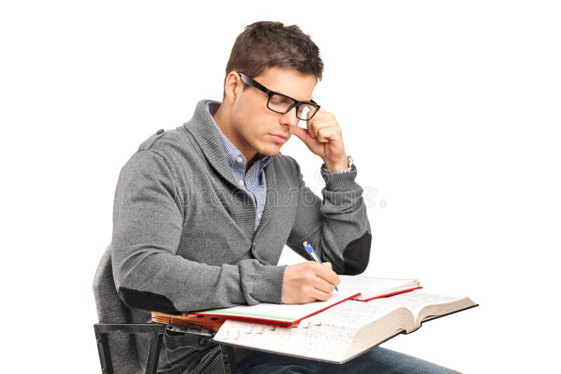 A young male in thoughts doing an exam stock photo
