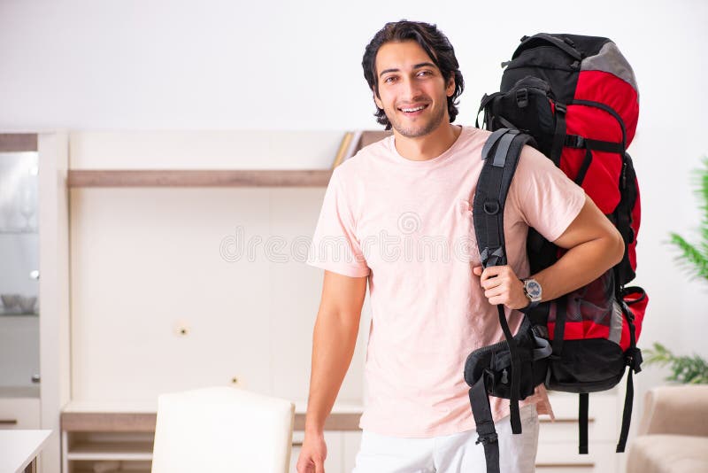 The Young Male Tourist Preparing For Trip At Home Stock Image - Image ...